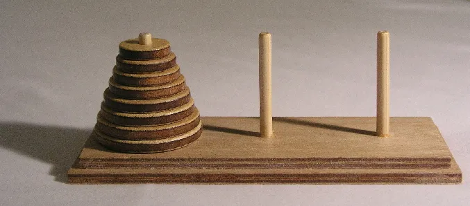 Tower of Hanoi puzzle with wooden discs on three pegs